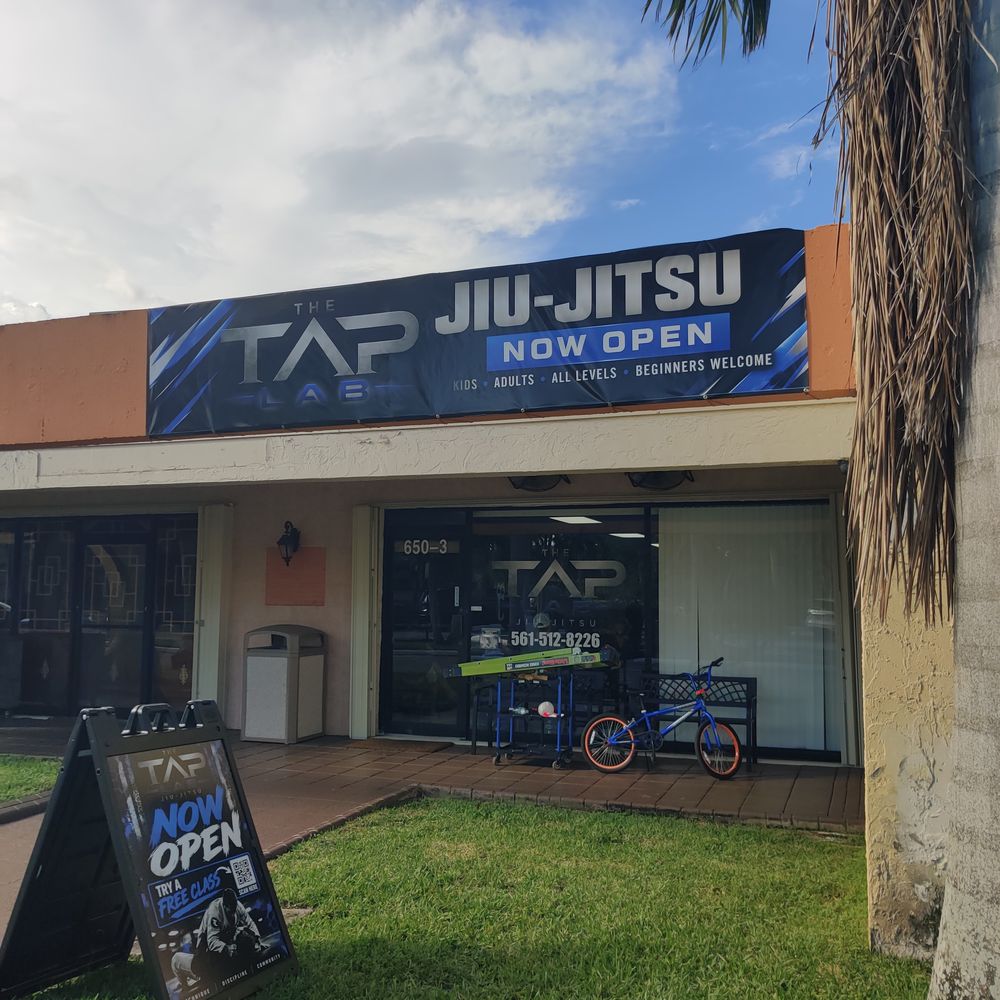 Storefront with a banner, window vinyl and an A-frame sign